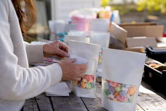 Hands labeling freeze-dried candy bag