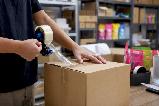 Hands sealing box with packaging tape