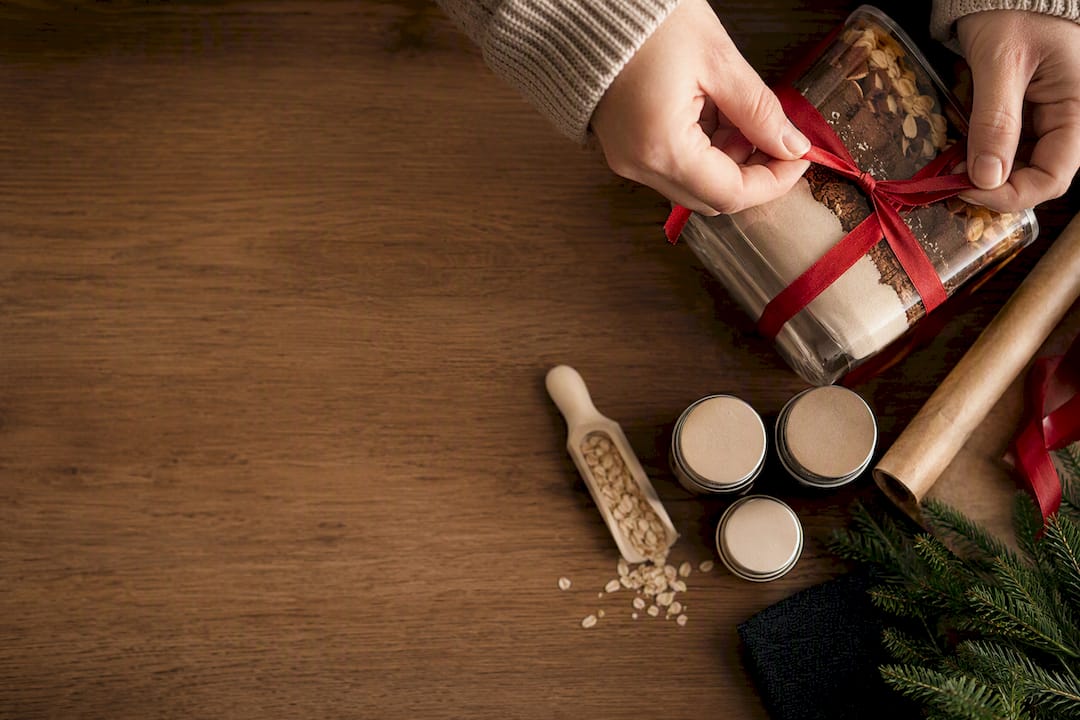 Hands packaging a cute Christmas food gift