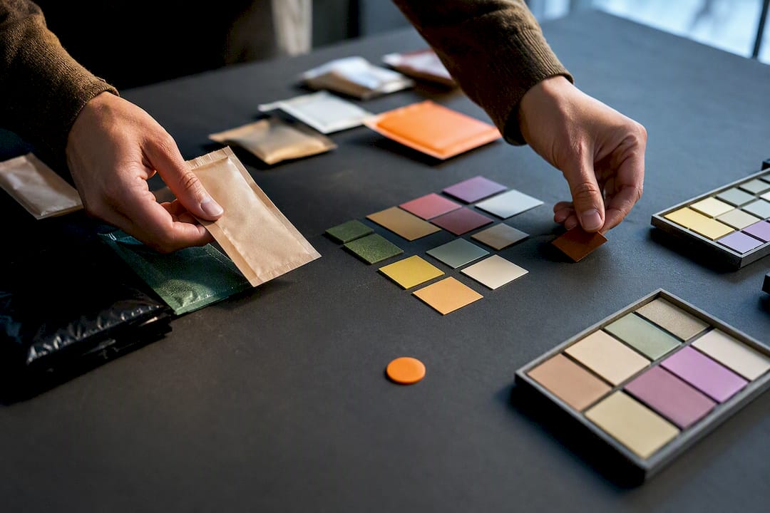 Hands comparing anonymous FMCG package samples